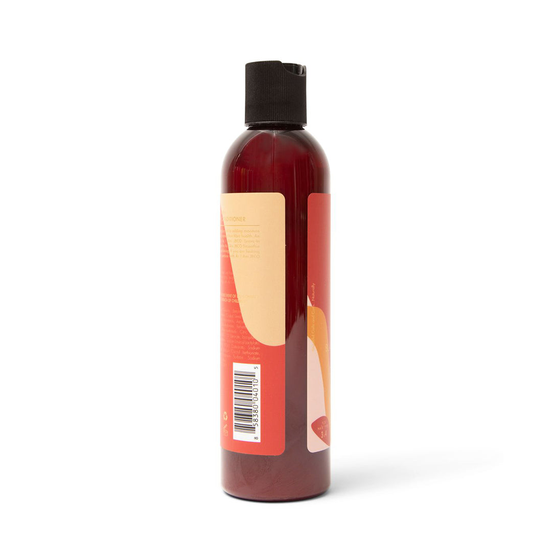Siden af en mørk flaske As I Am Jamaican Black Castor Oil Leave-in Conditioner (237 ml) med en beige og lyserød etiket, der viser en stregkode og dele af produktinformationen.